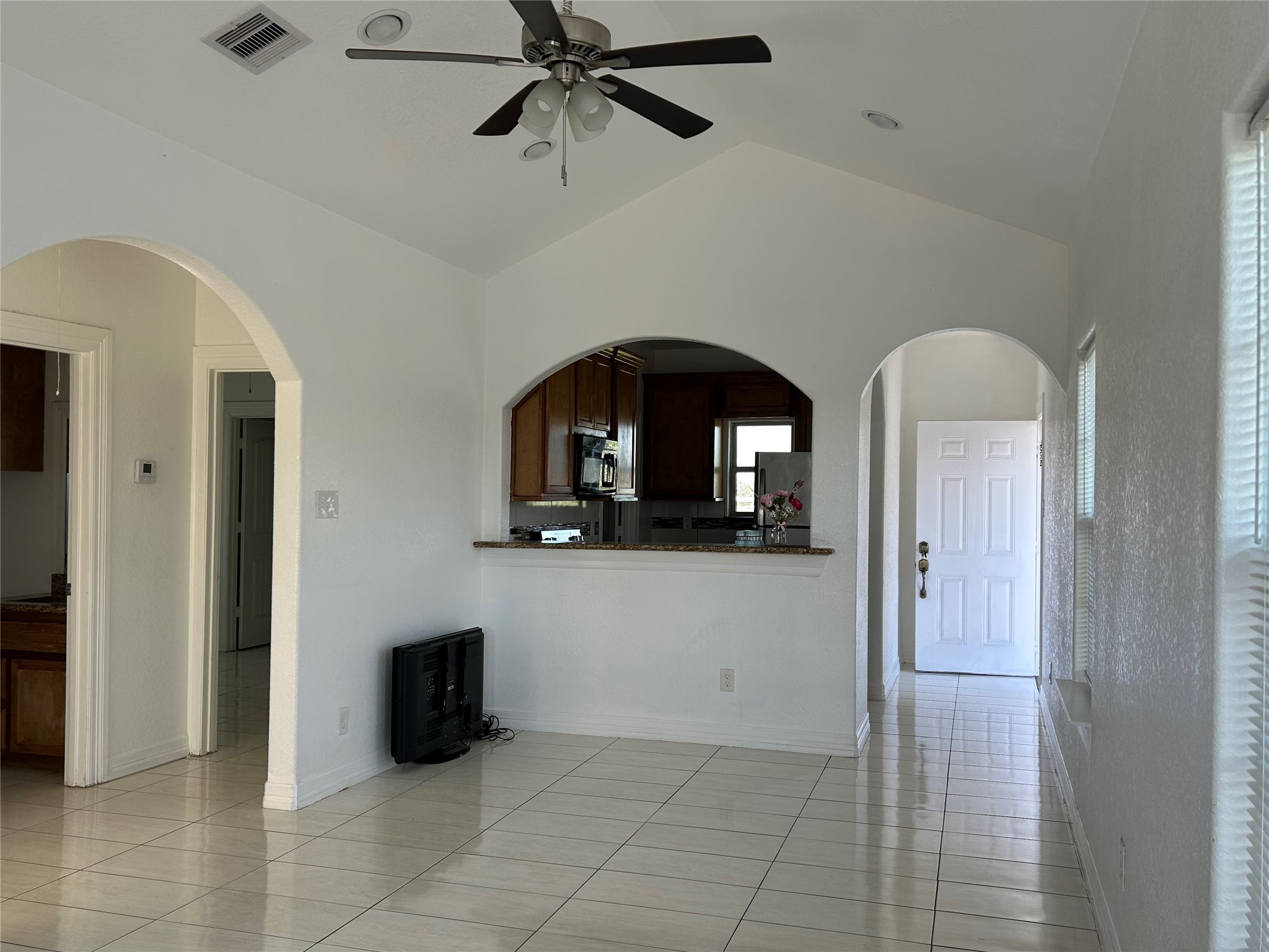 a living room with a mirror furniture and a rug
