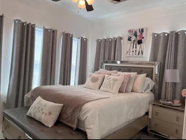 a bed sitting in a bedroom next to a window