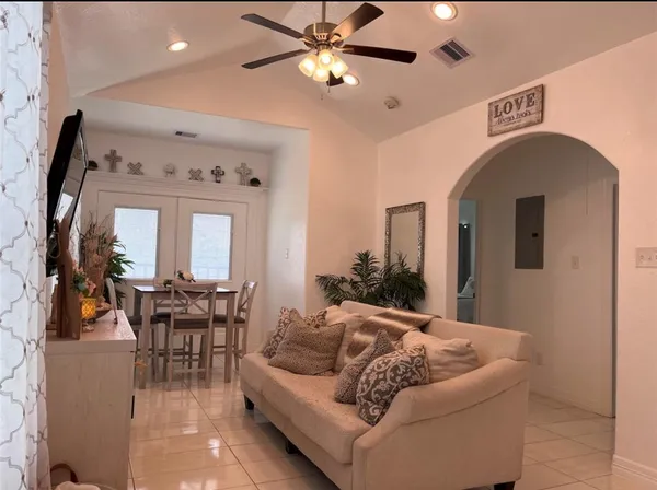 a living room with furniture and a chandelier