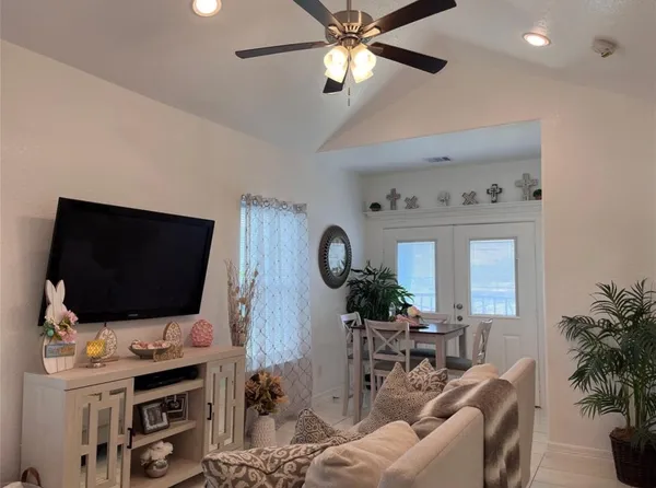 a living room with furniture and a flat screen tv