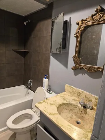 a bathroom with a sink a toilet and bathtub