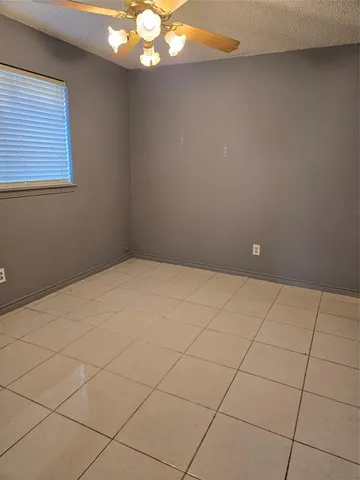a view of a room that has a bed and a chandelier