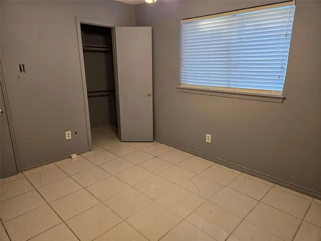 an empty room with a wooden cabinet