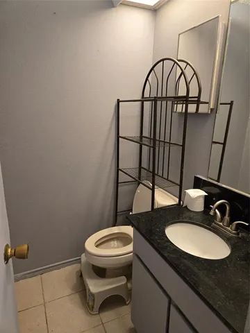 a bathroom with a toilet a sink and a mirror