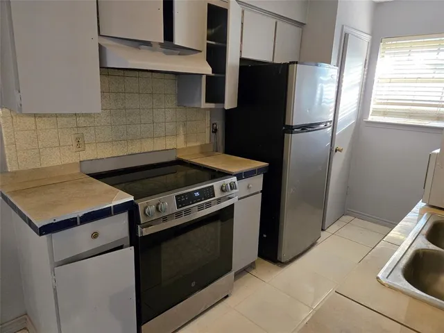 a kitchen with a stove microwave and refrigerator