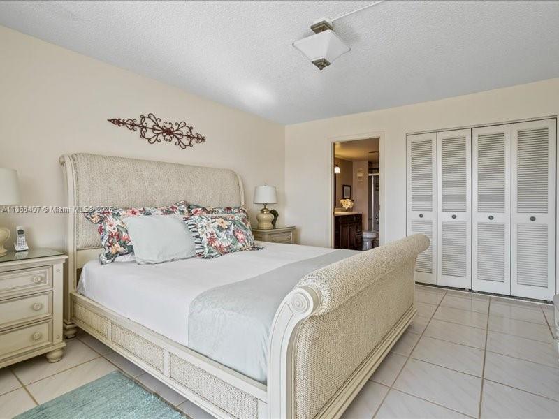 6200 Northwest 2nd Avenue, Unit 418 Boca Raton, FL 33487 - Photo 15 of 41 a bedroom with a large bed and walk in closet