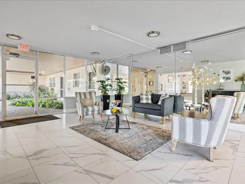 6200 Northwest 2nd Avenue, Unit 418 Boca Raton, FL 33487 - Photo 23 of 41 a living room with furniture and a chandelier