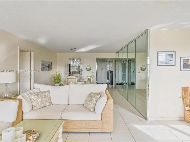 a living room with furniture and a glass door