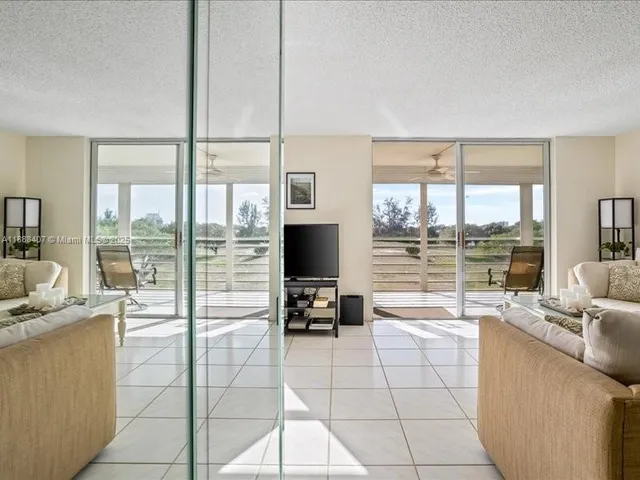 a room with a large window and a view of living room