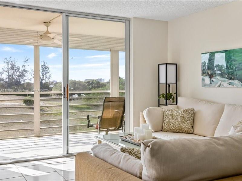 6200 Northwest 2nd Avenue, Unit 418 Boca Raton, FL 33487 - Photo 32 of 41 a living room with furniture and a large window