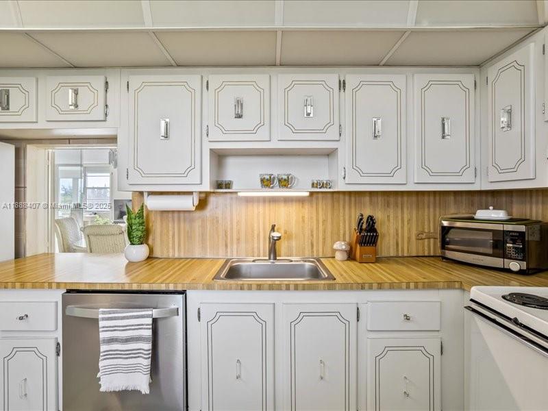 6200 Northwest 2nd Avenue, Unit 418 Boca Raton, FL 33487 - Photo 37 of 41 a kitchen with stainless steel appliances granite countertop a sink and cabinets