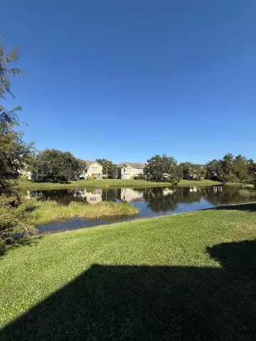 a view of a lake with houses in the back