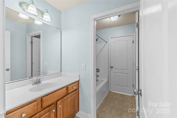a bathroom with a sink a vanity and a mirror