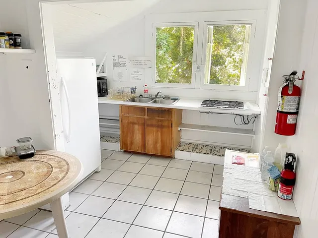 a kitchen with stainless steel appliances a sink and a refrigerator