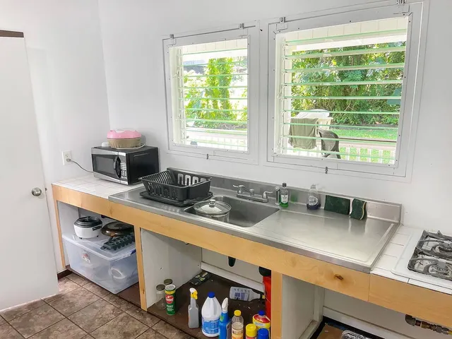 a kitchen with stainless steel appliances a sink a stove and a window