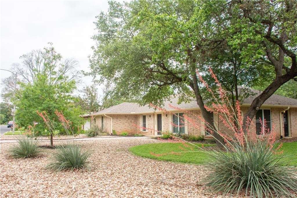 7000 Greenock Street Austin, TX 78749 - Photo 1 of 22 a front view of a house with a yard and shrubs