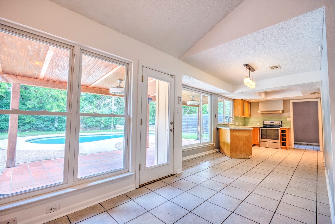 7000 Greenock Street Austin, TX 78749 - Photo 8 of 22 a view of a room with kitchen island furniture and a large window