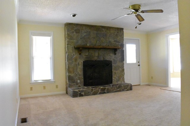 4430 Jones Road Macon, GA 31216 - Photo 13 of 28 an empty room with windows and fireplace