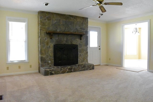 4430 Jones Road Macon, GA 31216 - Photo 14 of 28 an empty room with a fireplace and windows