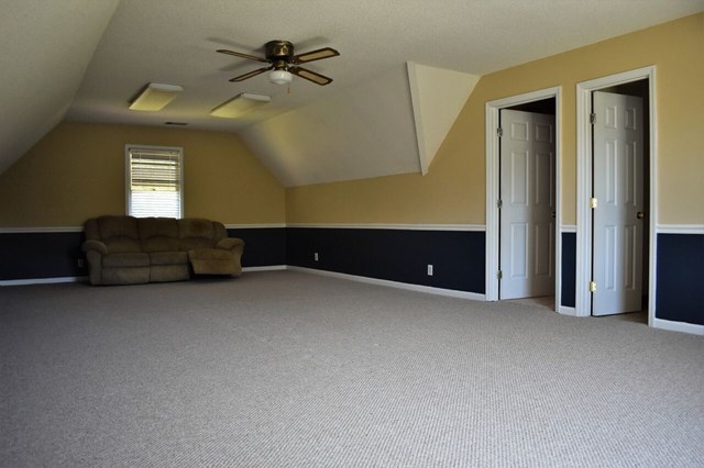 4430 Jones Road Macon, GA 31216 - Photo 19 of 28 a view of a big room with windows and chandelier fan
