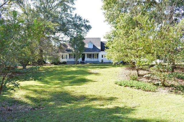 4430 Jones Road Macon, GA 31216 - Photo 3 of 28 a view of a house with a big yard and large trees