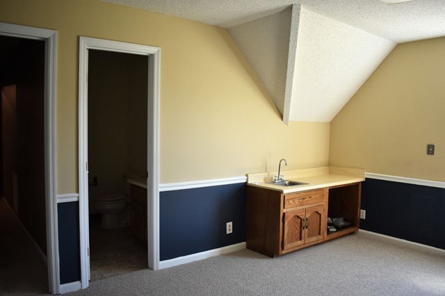 4430 Jones Road Macon, GA 31216 - Photo 21 of 28 a room with a wooden cabinets and sink