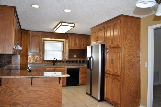 4430 Jones Road Macon, GA 31216 - Photo 7 of 28 a kitchen with granite countertop a refrigerator and a sink