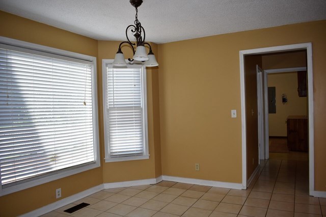 4430 Jones Road Macon, GA 31216 - Photo 8 of 28 a view of empty room with window and chandelier