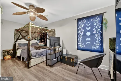 a bedroom with a bed and lamp on desk