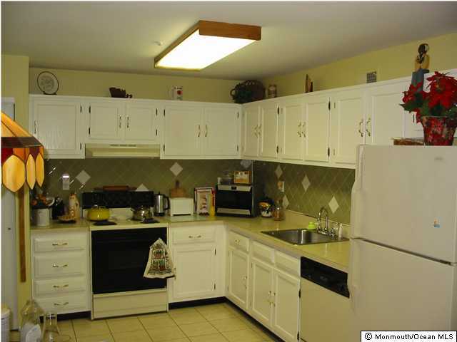 136 Rigi Strasse, Unit A Freehold, NJ 07728 - Photo 3 of 3 a kitchen with a sink and cabinets