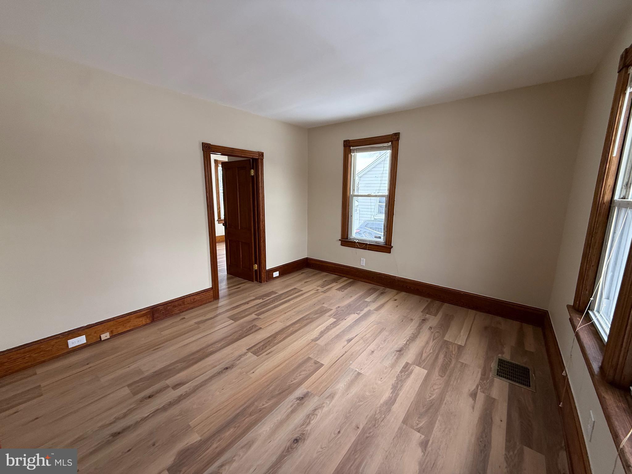 1403 Rancocas Road, Unit 1 Burlington, NJ 08016 - Photo 2 of 9 an empty room with wooden floor and windows
