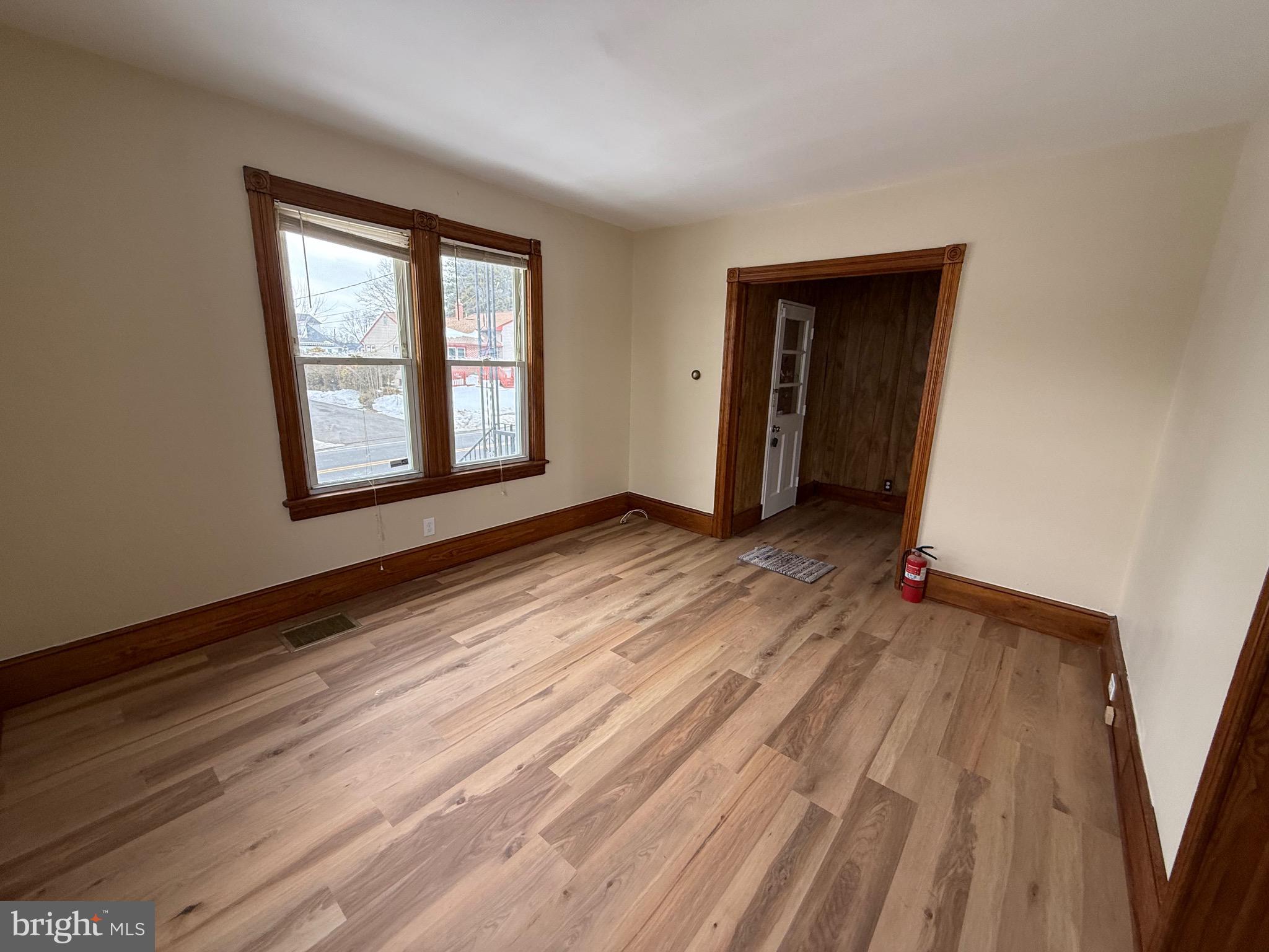 1403 Rancocas Road, Unit 1 Burlington, NJ 08016 - Photo 3 of 9 a view of an empty room with wooden floor and a window
