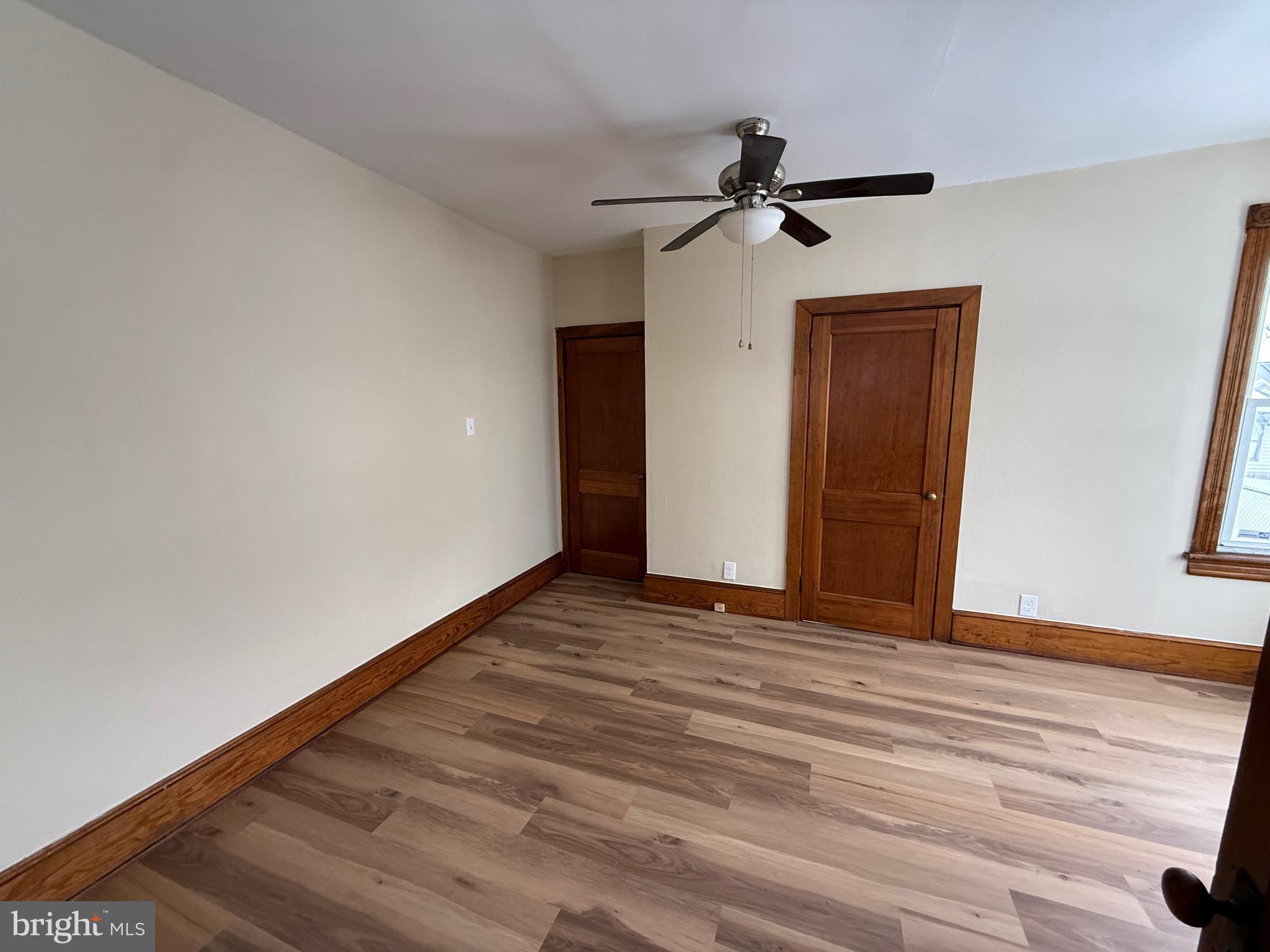 1403 Rancocas Road, Unit 1 Burlington, NJ 08016 - Photo 4 of 9 a view of a livingroom with wooden floor and a ceiling fan