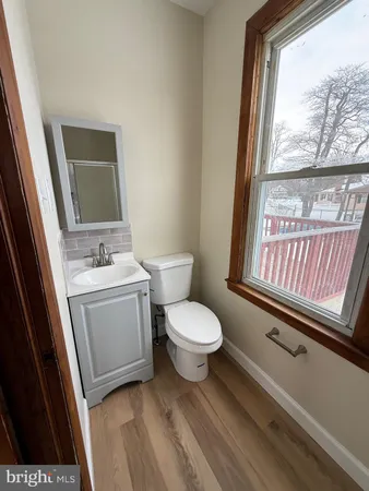 a bathroom with a toilet sink and mirror