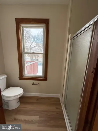 a bathroom with a toilet tub and a window