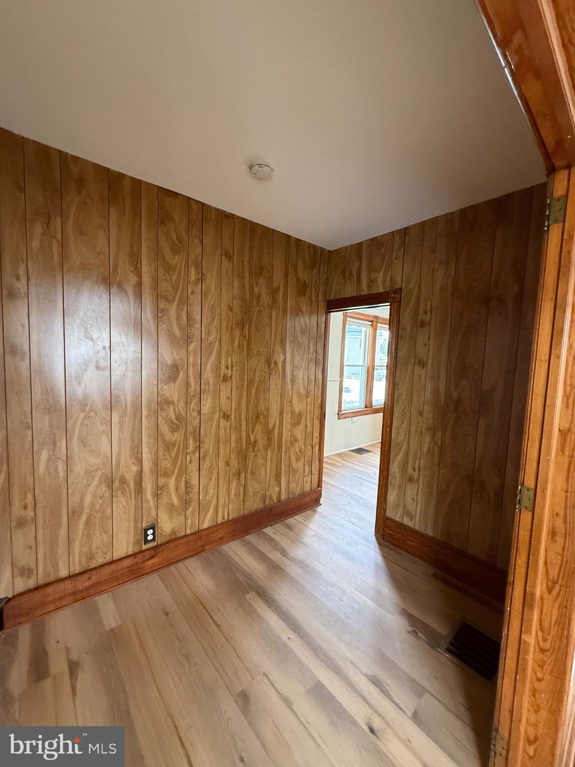 1403 Rancocas Road, Unit 1 Burlington, NJ 08016 - Photo 8 of 9 a view of an empty room with wooden floor and a window