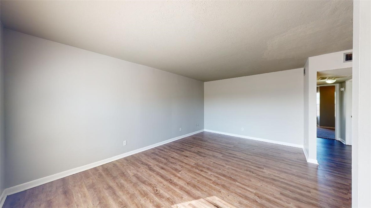 3800 East 29th Street, Unit 15 Bryan, TX 77802 - Photo 3 of 20 a view of an empty room and wooden floor