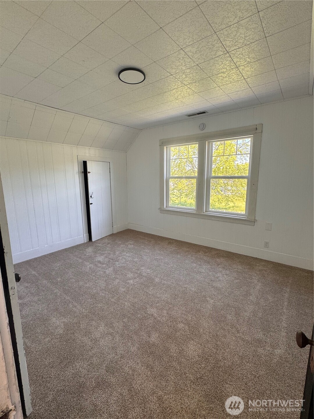 20016 Orville Road East Orting, WA 98360 - Photo 15 of 18 a view of an empty room with windows
