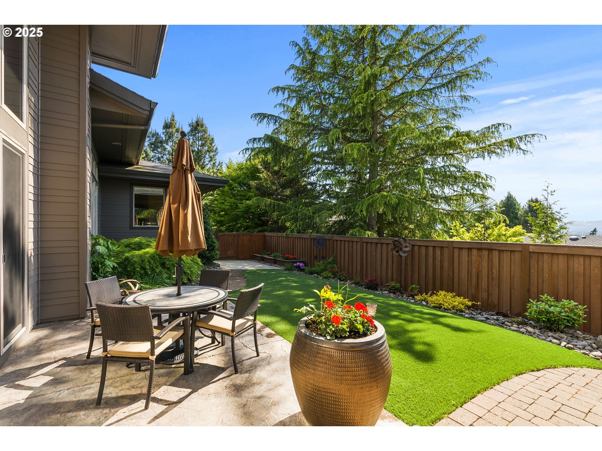 14217 155th Terrace Portland, OR 97224 - Photo 2 of 41 a view of a chair and tables in the back yard of the house