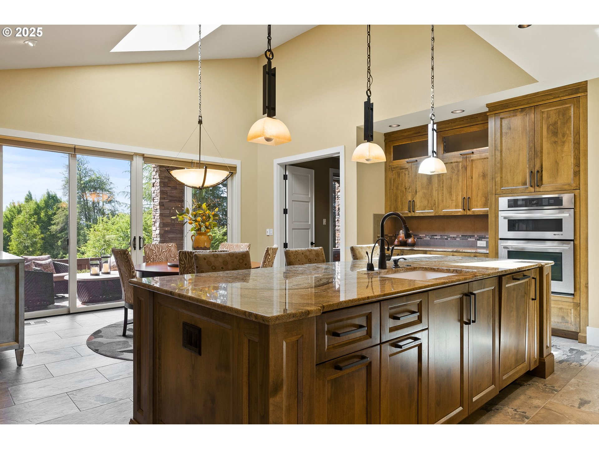 14217 155th Terrace Portland, OR 97224 - Photo 7 of 41 a kitchen with stainless steel appliances granite countertop a sink a counter space and a view of living room