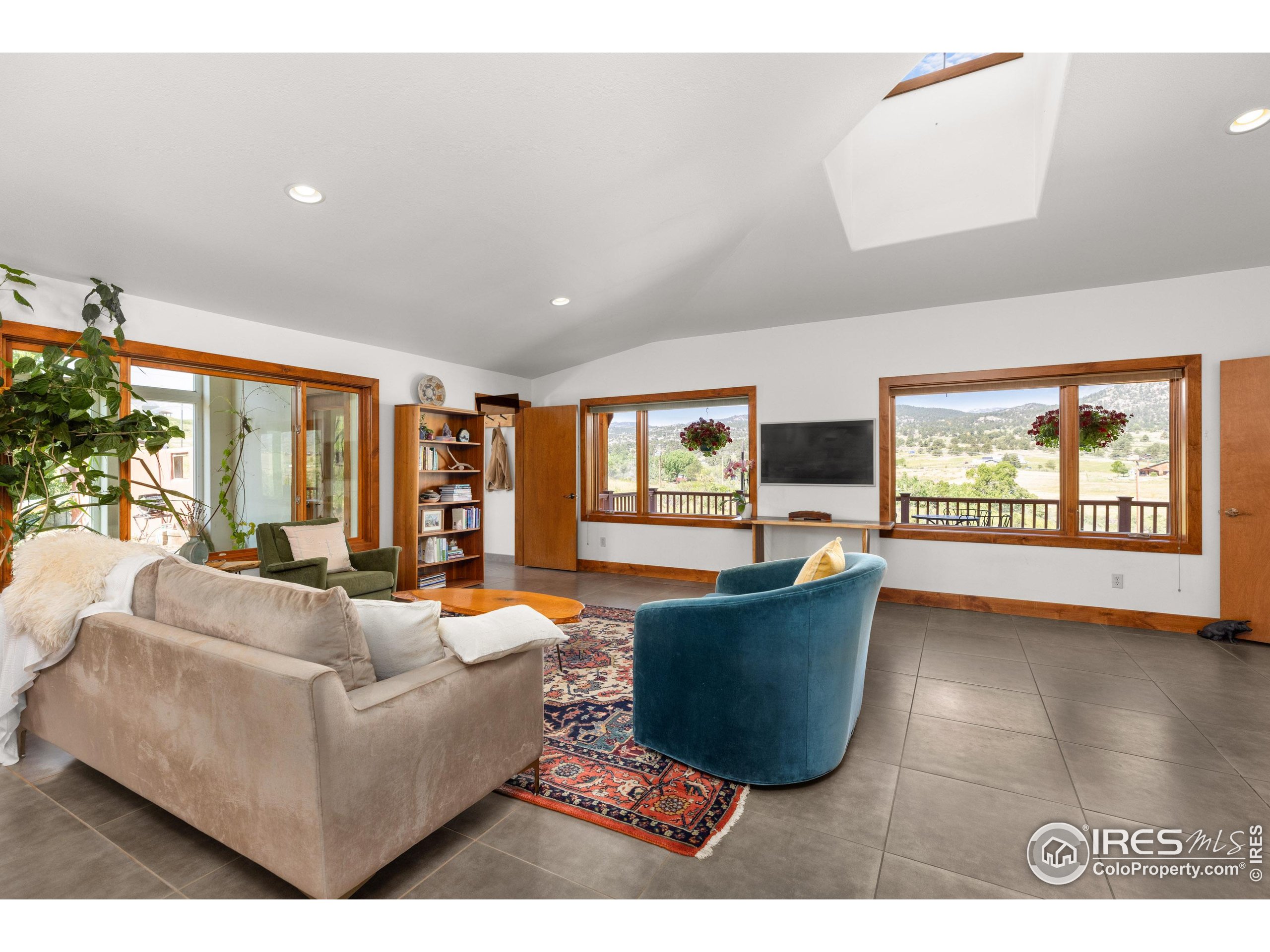 108 Lone Star Road Lyons, CO 80540 - Photo 15 of 38 a living room with furniture large window and flat screen tv