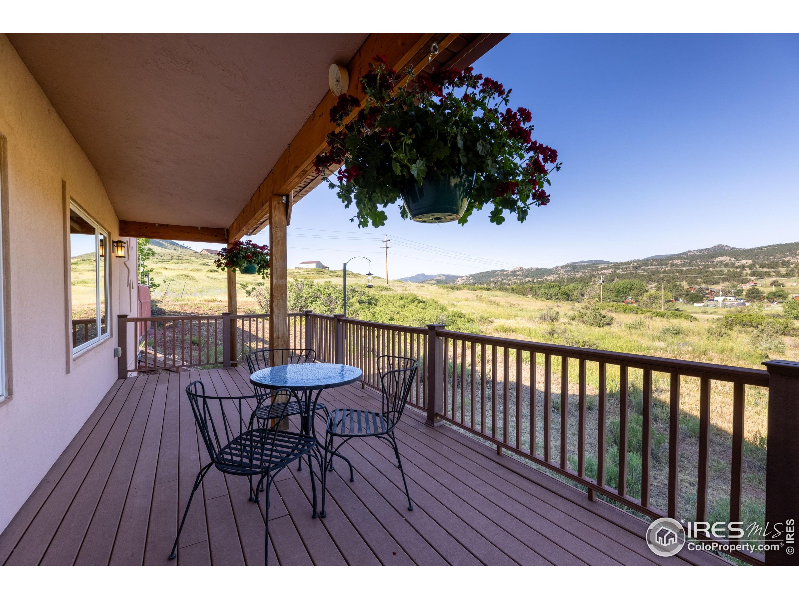 108 Lone Star Road Lyons, CO 80540 - Photo 27 of 38 a view of a balcony with furniture and wooden floor
