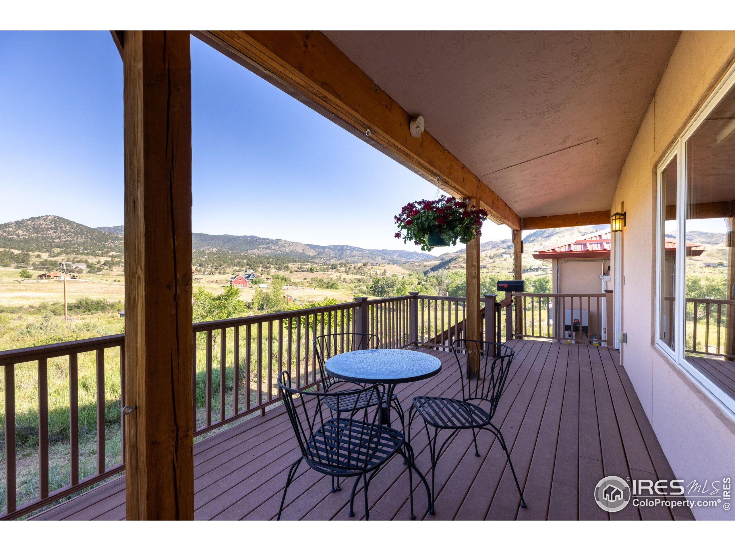 108 Lone Star Road Lyons, CO 80540 - Photo 4 of 38 a view of a balcony with furniture and wooden floor
