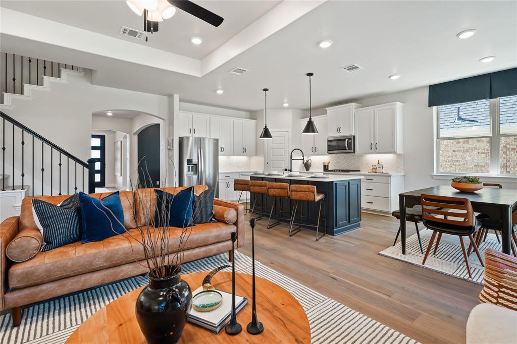 8717 Kentucky Derby Street Pilot Point, TX 76258 - Photo 5 of 18 a living room with furniture kitchen view and a wooden floor