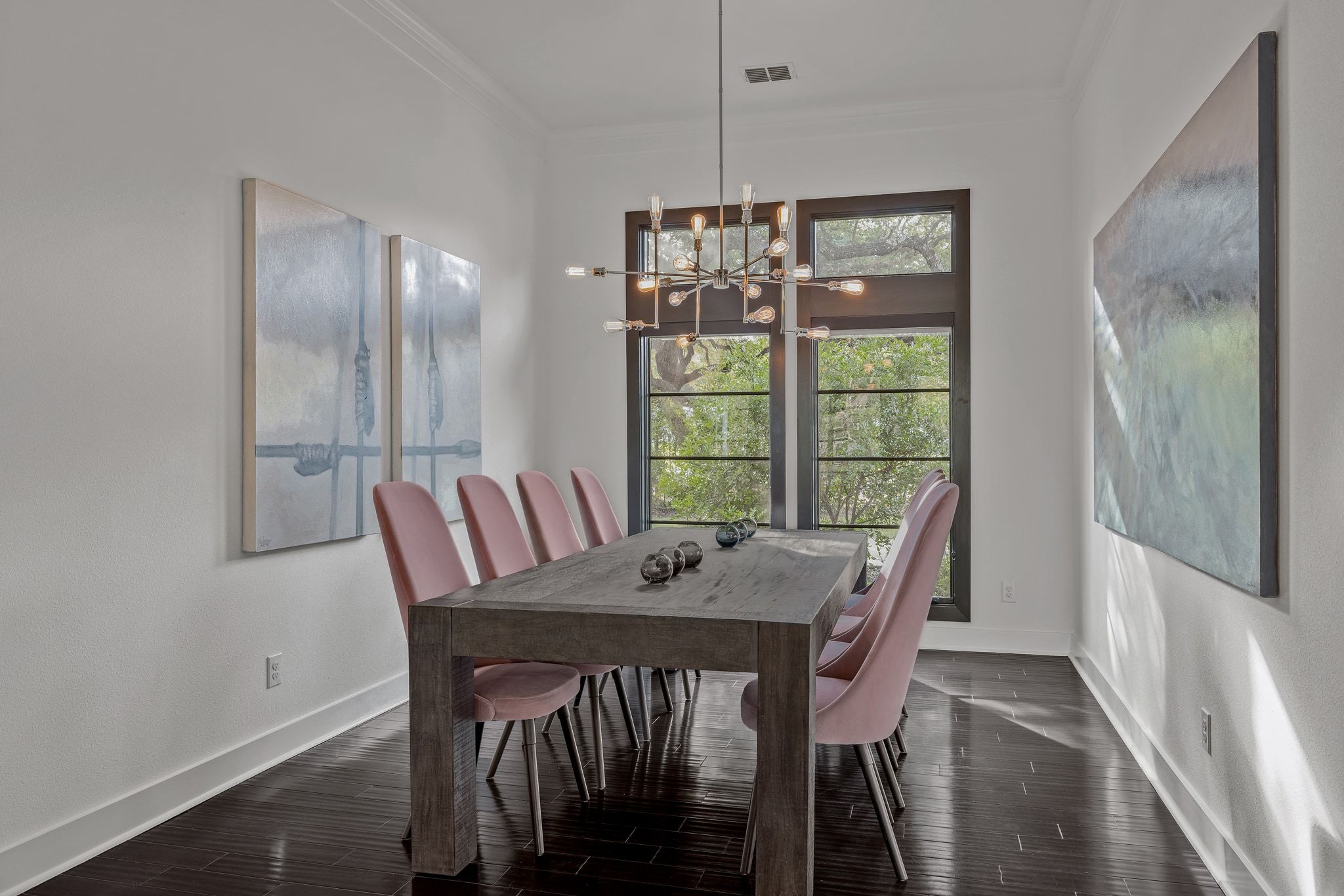 4720 Rockcliff Road, Unit 1 Austin, TX 78746 - Photo 19 of 39 Hardwood floors and a striking modern chandelier define this elegant dining space.