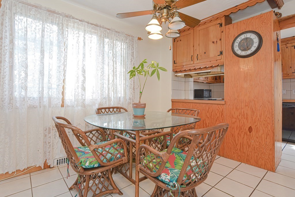 16 Rosedale Avenue Everett, MA 02149 - Photo 11 of 29 a kitchen with a dining table and chairs