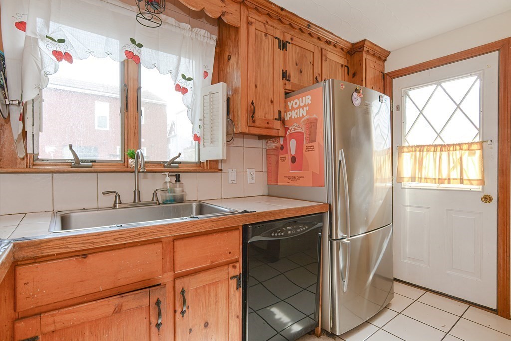 16 Rosedale Avenue Everett, MA 02149 - Photo 12 of 29 a kitchen with stainless steel appliances a sink and a window
