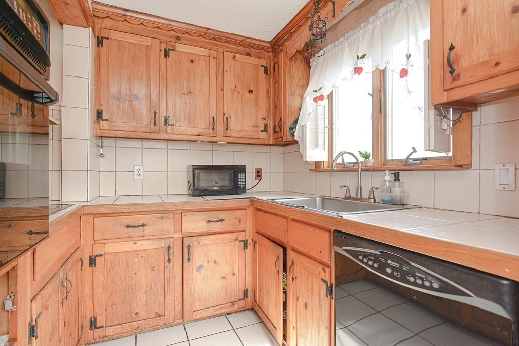 16 Rosedale Avenue Everett, MA 02149 - Photo 13 of 29 a kitchen with stainless steel appliances granite countertop a sink and a cabinets