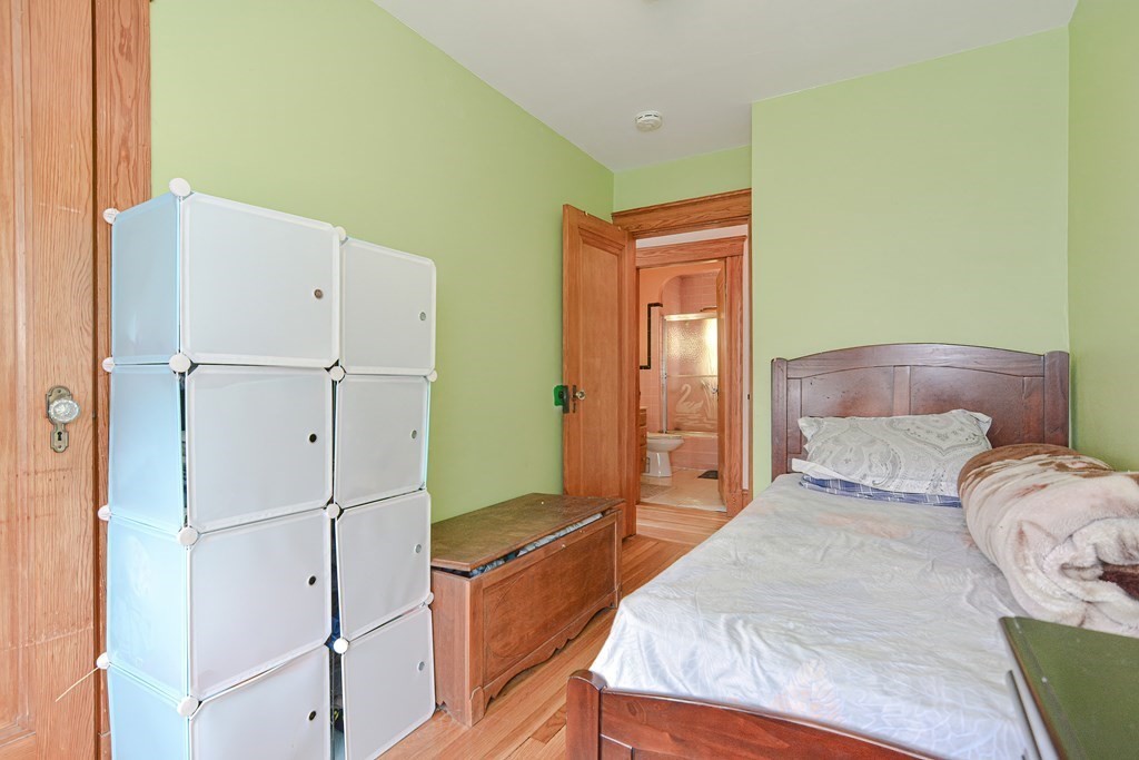 16 Rosedale Avenue Everett, MA 02149 - Photo 15 of 29 a bedroom with a bed and a refrigerator