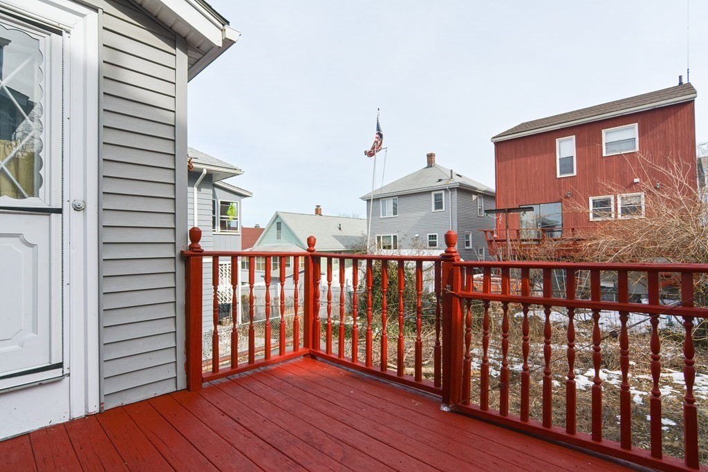 16 Rosedale Avenue Everett, MA 02149 - Photo 26 of 29 a view of a brick house with wooden floor and fence
